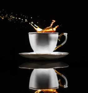 coffee splashes in white cup on black background