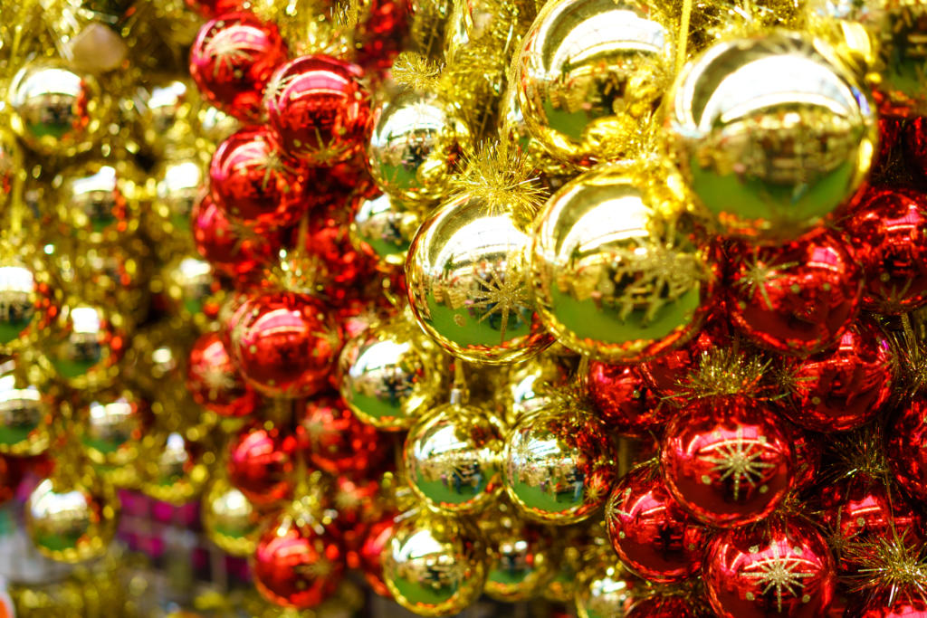 lot of christmas glass red and yellow balls are hanging in the store festive new year decor