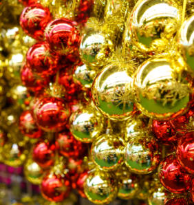 lot of christmas glass red and yellow balls are hanging in the store festive new year decor